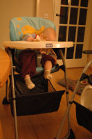 Alexandra sleeping in her highchair