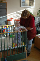 Caroline standing with help from grandma Emmy