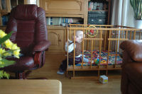 Alexandra sitting in the playpen