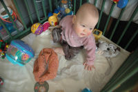 Caroline turns the playpen into a sandpit