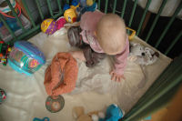 Caroline turns the playpen into a sandpit