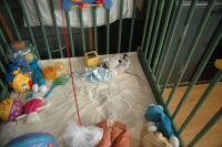 Caroline turns the playpen into a sandpit