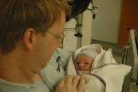 Dad holds his new daughter for the first time