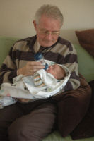 Granddad is feeding Madeleine