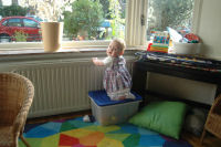  Madeleine climbs on a box to look out through he window