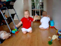 Caroline and Alexandra crawling upright,<br>Caroline wearing red, Alexandra white