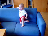 Caroline climbing onto the couch